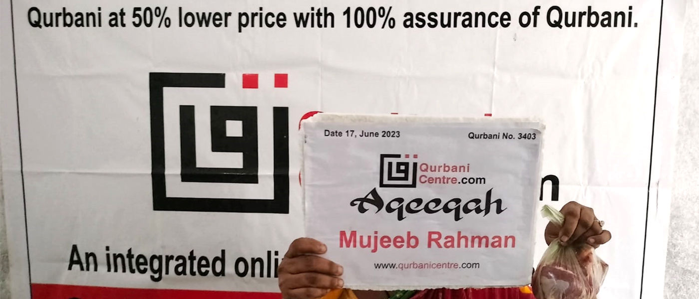 a person holding a Aqeeqa Board At Qurbani Centre